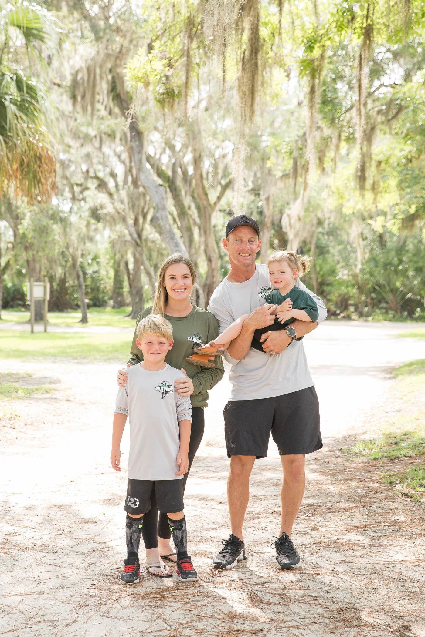 The Canopy Carvers family under Florida oak trees draped in Spanish moss
